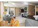 Open living room features a fireplace and built-in shelving, seamlessly connecting to the kitchen at 4236 Lark Sparrow St, Highlands Ranch, CO 80126