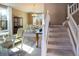 Elegant staircase with a carpeted runner and white railings at 4236 Lark Sparrow St, Highlands Ranch, CO 80126