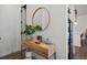 Light and bright entryway with console table, mirror, and plants at 3061 Low Meadow Blvd, Castle Rock, CO 80109