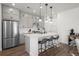 Modern kitchen with gray cabinets, white quartz island, and stainless steel appliances at 3061 Low Meadow Blvd, Castle Rock, CO 80109