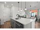 Modern kitchen island with white quartz countertop and stainless steel sink at 3061 Low Meadow Blvd, Castle Rock, CO 80109