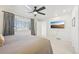 Bright bedroom with large window, ceiling fan, and wall-mounted TV at 3257 S Pontiac St, Denver, CO 80224