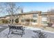 Brick townhouse with a landscaped front yard and snow at 3257 S Pontiac St, Denver, CO 80224