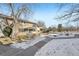 Townhouse exterior showcasing a walkway and snowy landscaping at 3257 S Pontiac St, Denver, CO 80224