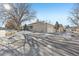 Townhouse showcasing side view with driveway and landscaping at 3257 S Pontiac St, Denver, CO 80224