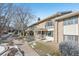 Townhouse with landscaping, walkway, and snowy ground at 3257 S Pontiac St, Denver, CO 80224