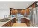 Modern kitchen with dark wood cabinets and stainless steel appliances at 3257 S Pontiac St, Denver, CO 80224