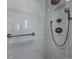 Modern shower with gray tile, rainfall shower head, and bronze fixtures at 3257 S Pontiac St, Denver, CO 80224