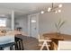 Dining area features a modern chandelier and stylish wood dining set at 1020 Stuart, Denver, CO 80204