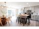 Open-concept kitchen with island, stainless steel appliances and adjacent dining area at 1020 Stuart, Denver, CO 80204