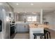 Updated kitchen with butcher block island, stainless steel appliances, and gray cabinets at 1020 Stuart, Denver, CO 80204