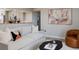 Comfortable living room showcasing a sofa, artwork, hardwood floors, and a stylish chair at 1020 Stuart, Denver, CO 80204