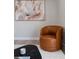 Living room boasting a brown leather chair, black table, and modern decor at 1020 Stuart, Denver, CO 80204