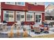 Charming outdoor back patio featuring comfortable seating, a built-in grill, and a retractable awning for shade at 1015 Auburn Dr, Erie, CO 80516