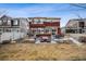 The home's backyard includes a patio, dining set, outdoor kitchen, and lush landscaping, perfect for entertaining guests outdoors at 1015 Auburn Dr, Erie, CO 80516