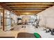 An unfinished basement with exposed ceiling beams awaits customization, perfect for creating a home gym or recreational space at 1015 Auburn Dr, Erie, CO 80516