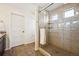 A tiled shower with a glass door, complemented by a neutral color scheme and modern fixtures, provides a luxurious bathroom experience at 1015 Auburn Dr, Erie, CO 80516