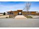 Community clubhouse with covered entrance, wood siding, brick accents, and well-maintained landscaping at 1015 Auburn Dr, Erie, CO 80516
