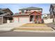 Charming two-story red home with well-kept lawn and two-car garage at 1015 Auburn Dr, Erie, CO 80516