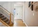 Bright entryway featuring a wooden staircase and light hardwood floors at 1015 Auburn Dr, Erie, CO 80516