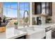 Stylish kitchen featuring white countertops and stainless steel fixtures under a window at 1015 Auburn Dr, Erie, CO 80516