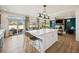 Bright, open kitchen area with hardwood floors, a white kitchen island, and lots of natural light at 1015 Auburn Dr, Erie, CO 80516