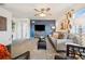 Cozy living room with soft carpet, sleek furniture, a modern ceiling fan and accent wall at 1015 Auburn Dr, Erie, CO 80516