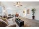Bright upper living room offers comfortable seating, sleek black coffee table, and access to adjacent bedrooms at 1015 Auburn Dr, Erie, CO 80516