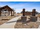 Rolling Prairie Park entrance sign with a covered picnic shelter on a sunny day at 1015 Auburn Dr, Erie, CO 80516