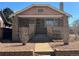 Charming brick home featuring a quaint front porch and detailed brickwork at 1992 S Lincoln St, Denver, CO 80210