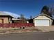 Detached two-car garage with a red fence and a clear blue sky backdrop at 1992 S Lincoln St, Denver, CO 80210