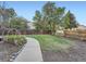 Backyard featuring a lush lawn, garden beds, and a greenhouse perfect for outdoor enjoyment at 4063 S Cathay Ct, Aurora, CO 80013