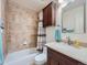 Bathroom features a shower-tub combo with decorative tiles, and single sink vanity at 4063 S Cathay Ct, Aurora, CO 80013