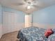 Bright bedroom featuring closet storage, neutral carpeting, and soft blue walls at 4063 S Cathay Ct, Aurora, CO 80013