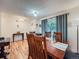 Inviting dining room featuring hardwood floors, natural light and a classic dining set at 4063 S Cathay Ct, Aurora, CO 80013