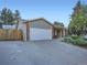 Home with a large garage and a driveway, complemented by a beautifully landscaped front yard at 4063 S Cathay Ct, Aurora, CO 80013