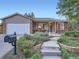 Charming home featuring brick and siding, a well-manicured yard and a cozy front porch at 4063 S Cathay Ct, Aurora, CO 80013