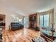 Spacious living room with hardwood floors, a cozy brick fireplace, and sliding door to the patio at 4063 S Cathay Ct, Aurora, CO 80013
