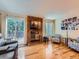 Cozy living room featuring a brick fireplace, hardwood floors, and sliding door to backyard at 4063 S Cathay Ct, Aurora, CO 80013