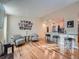 Inviting living room featuring hardwood floors and an open layout with bar seating to the kitchen at 4063 S Cathay Ct, Aurora, CO 80013