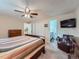 This bright main bedroom features plush carpets, ceiling fan and includes a private ensuite bathroom at 4063 S Cathay Ct, Aurora, CO 80013