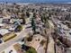 Aerial view of a neighborhood featuring mature trees, solar panels, and well-maintained streets at 13640 W Center Dr, Lakewood, CO 80228