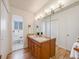 Bathroom featuring double sinks, hardwood floors and a door leading to a separate room at 13640 W Center Dr, Lakewood, CO 80228