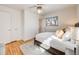 Serene bedroom with neutral colors, a plush rug, and plenty of natural light from the window at 13640 W Center Dr, Lakewood, CO 80228