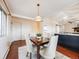 Inviting dining room adjacent to the kitchen, with a table set for four and ample natural light at 13640 W Center Dr, Lakewood, CO 80228