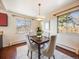 Cozy dining area illuminated by natural light from multiple windows, featuring a table with seating for four at 13640 W Center Dr, Lakewood, CO 80228