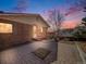 Charming brick home exterior with a cozy porch and sunset sky creating a welcoming atmosphere at 13640 W Center Dr, Lakewood, CO 80228