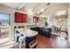 Bright kitchen featuring an island, colorful backsplash, red upper cabinets, and adjacent dining area at 13640 W Center Dr, Lakewood, CO 80228