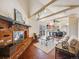 Cozy living room with a brick fireplace, exposed beams, and an open layout at 13640 W Center Dr, Lakewood, CO 80228