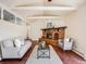 Cozy living room with a brick fireplace, exposed ceiling beams, and neutral colored furniture at 13640 W Center Dr, Lakewood, CO 80228